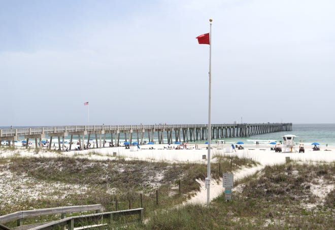 A single red flag flies Monday at the M.B. Miller County Pier. [PATTI BLAKE/THE NEWS HERALD]