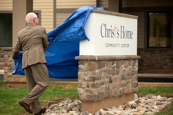 Vernon Wright, chief development officer of Christ's Home, unveils a sign outside their new community center Tuesday, June 19, 2018 in Warminster. [BILL FRASER / STAFF PHOTOJOURNALIST]