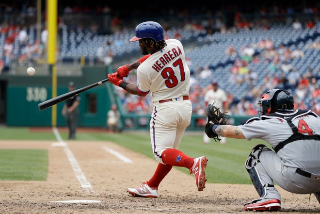 The Phillies' Odubel Herrera hits a home run off Cardinals relief pitcher Sam Tuivailala during Wednesday's game. [MATT SLOCUM/THE ASSOCIATED PRESS]