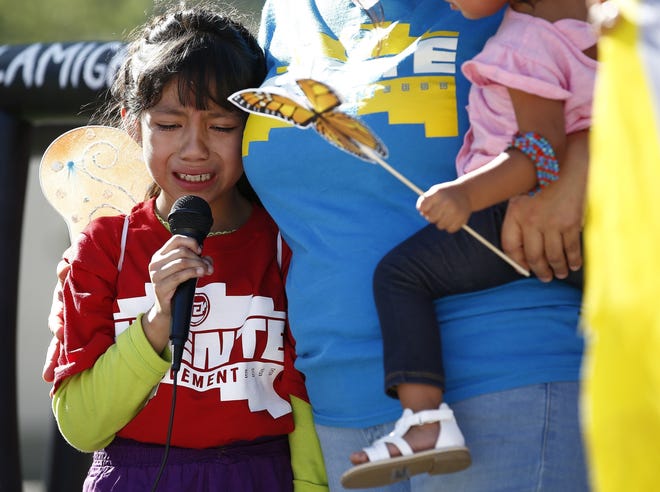 FILE - In this Monday, June 18, 2018 file photo, Akemi Vargas, 8, cries as she talks about being separated from her father during an immigration family separation protest in front of the Sandra Day O'Connor U.S. District Court building in Phoenix. Child welfare agencies across America make wrenching decisions every day to separate children from their parents. But those agencies have ways of minimizing the trauma that aren't being employed by the Trump administration at the Mexican border. (AP Photo/Ross D. Franklin, File)