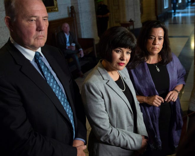 Minister of Justice and Attorney General of Canada Jody Wilson-Raybould, right, Minister of Health Ginette Petitpas Taylor, center, and Parliamentary Secretary to the Minister of Justice and Attorney General of Canada and to the Minister of Health Bill Blair, left, listen to questions during a press conference on Bill C-45, the Cannabis Act, in the Foyer of the House of Commons on Parliament Hill in Ottawa, Ontario on Wednesday, June 20, 2018. The Canadian government said it will soon announce the date of when cannabis will become legal, but warns it will remain illegal until then. (Justin Tang/The Canadian Press via AP)