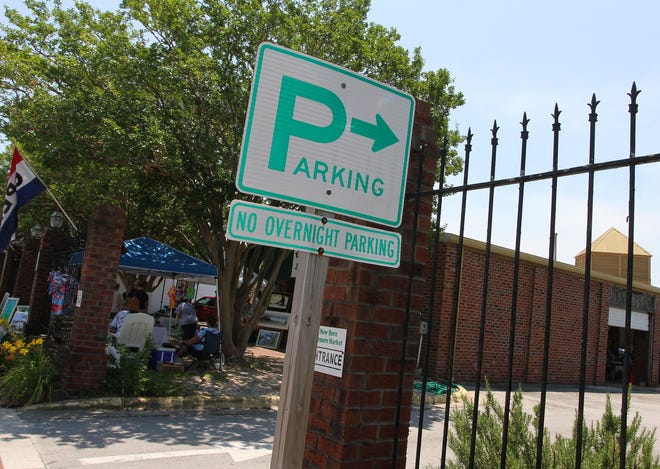 Signs are placed for designated parking areas at the Farmer's Market in downtown New Bern. [Gray Whitley / Sun Journal Staff]
