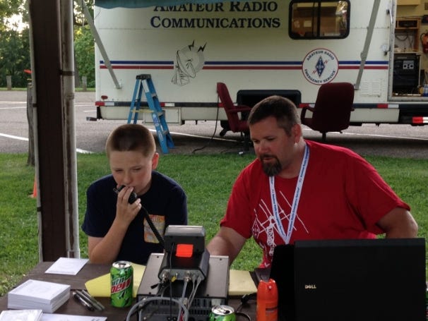 The Tusco Amateur Radio Club will participate in the national Amateur Radio Field Day from June 23 to 24 at Fort Laurens, 11067 Fort Laurens Road NW, Bolivar. Pictured: N8BAG Brent Gribble assists David Johnson, 14, in making his first radio contacts. David was inspired to take his technician exam and is now licensed as KE8HLC. PHOTO PROVIDED