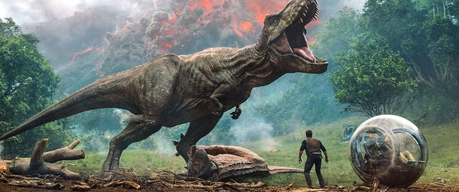 Owen (Chris Pratt) faces off against a vicious T. rex in "Jurassic World: Fallen Kingdom." [UNIVERSAL STUDIOS]