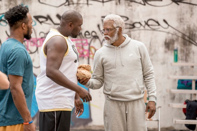 This image Boston Celtics basketball player Kyrie Irving, right, portraying Uncle Drew in a scene from the comedy "Uncle Drew." [Summit Entertainment]