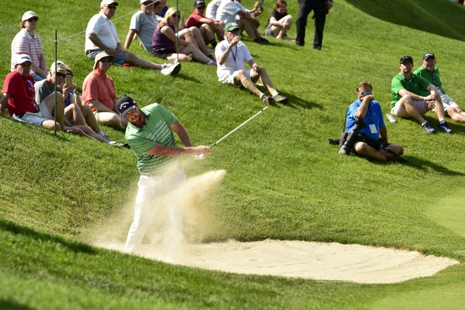 Marc Leishman hits from a bunker next to the 13th green during the first round of the Travelers Championship golf tournament at TPC River Highlands in Cromwell, Conn., Thursday, June 21, 2019. (John Woike/Hartford Courant via AP)