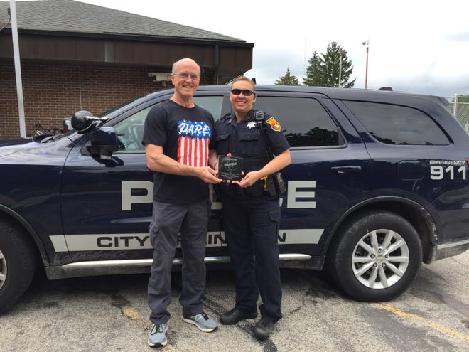DARE Officers Scott Brown and Christy Fruge outside the Logan County Safety Complex on Friday during the presentation of an award for Brown's 20 years of service with DARE. [Photo submitted]