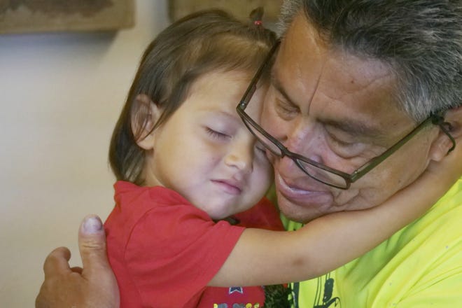 Romulo Gonzalez Rodriguez and his 3-year-old daughter Genesis hug during a interview June 19 in Provo, Utah. Gonzalez Rodriguez spoke about the anguish of being separated from his child, then 2 years old, for seven days in November after arriving to the U.S. port of entry in San Diego. Gonzalez Rodriguez said he fled his hometown of Champerico, Guatemala, to seek asylum in the United States after he was kidnapped and extorted by captors who cut out his eye and nearly killed him. (AP Photo/Rick Bowmer)