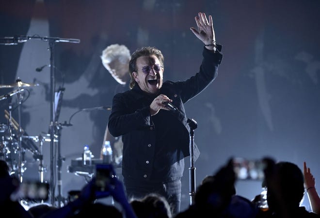 Singer Bono of U2 performs during a concert at the Apollo Theater June 11 in New York. [The Associated Press]