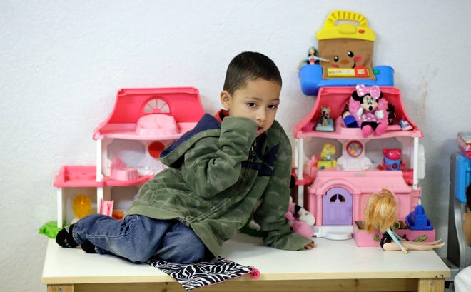 Jensen Torres, 4, an immigrant from Honduras, sits on a table as he waits with his family at the Catholic Charities RGV on Thursday, June 21, 2018, in McAllen, Texas. His family was processed and released by U.S. Customs and Border Protection Tuesday and are waiting to travel to New York. [David J. Phillip/AP]