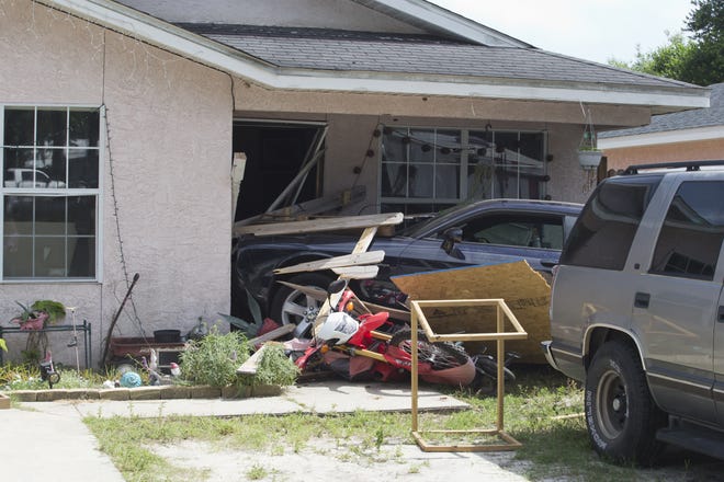 A black Dodge Challenger was driven off the road and into a home at 2501 W. 11th St. in Panama City on Friday afternoon. No one has home at the time, and the driver was not seriously injured. [JOSHUA BOUCHER/THE NEWS HERALD]