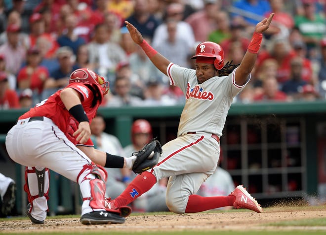 The Phillies' Maikel Franco slides home to score during the seventh inning against the Nationals on Saturday. [Nick Wass/Associated Press]