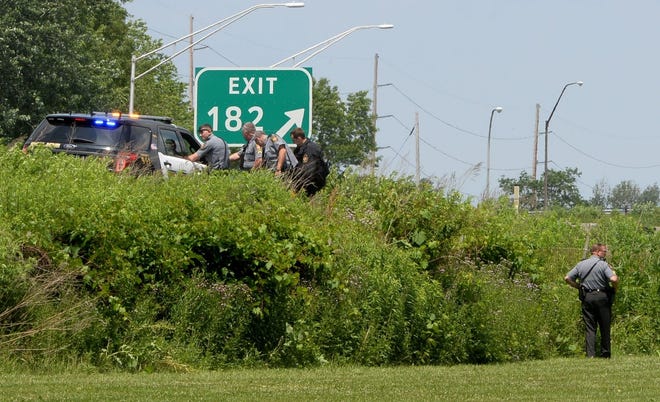 Pennsylvania State Police and Erie police search Saturday near Interstate 79 and Haggerty Park for a man who escaped from an Erie pre-release center earlier. [GREG WOHLFORD/ERIE TIMES-NEWS]