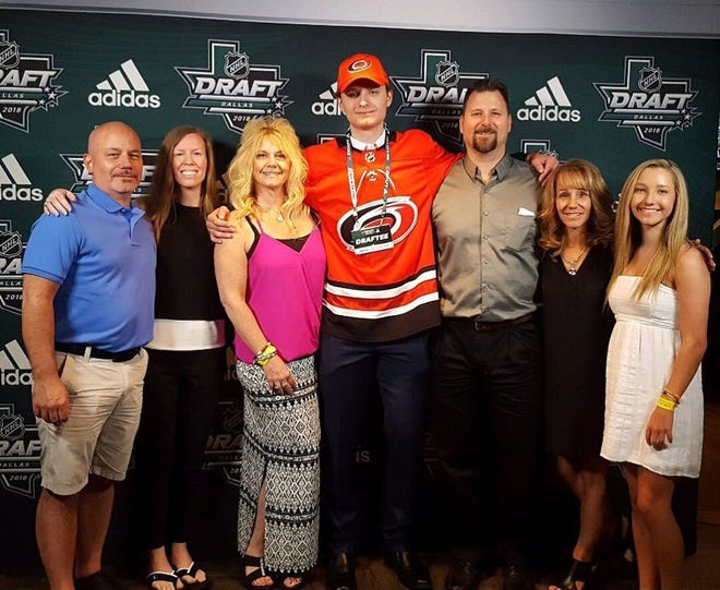 Jacob Kucharski, an Erie native and former Cathedral Prep goaltender, is surrounded by family after being selected in the seventh round of the NHL draft by the Carolina Hurricanes on Saturday at American Airlines Center in Dallas, Texas. [CONTRIBUTED PHOTO]