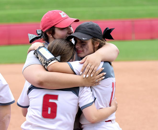 Crestwood assistant coach Carly Crouse hugs Christina Masiello, left, and Angela Masiello after the team's district final loss to Woodridge May 18.