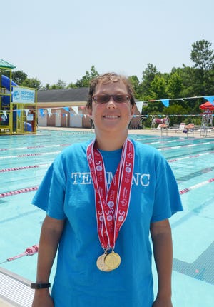 Special Olympics athlete Alyson Sheedy shows off medals she recently won in the Special Olympics Summer Games. Next month, Sheedy will become the first Craven County Special Olympics athlete to compete in the organization's USA Games in Seattle. [TODD WETHERINGTON / SUN JOURNAL STAFF]