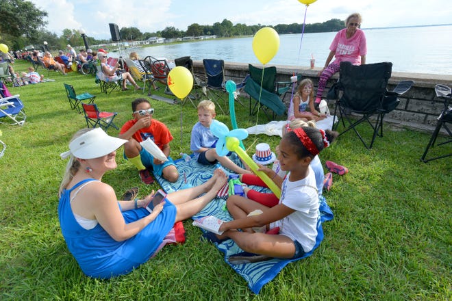 A group picnics near the water at Eustis' Hometown Celebration at Ferran Park on Friday, July 1, 2016 in Eustis, Fla. The event kicked off the Fourth of July Weekend with family fun, food and a water ski performance. (Amber Riccinto/ Daily Commercial)