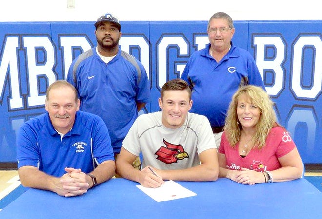 Cambridge senior Connor Leppla, center, is flanked by parents Tim and Leslie Leppla during a recent signing ceremony to attend Wheeling Jesuit University at Cambridge High School. Standing in the back row are CHS head baseball coach Jamaal Lowery and Cambridge High Athletic Director Dave Gray.