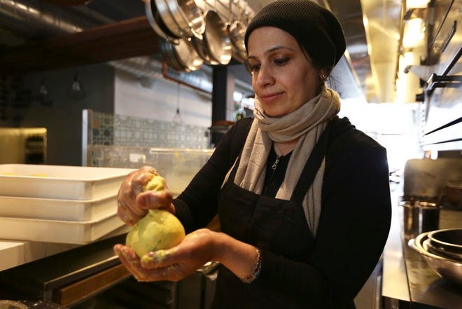Muna Anaee, prepares a ball of khobz orouk, a flatbread she would eat frequently in her native Iraq, at the Tawla restaurant kitchen in San Francisco during the inaugural Refugee Food Festival. San Francisco restaurants are opening their kitchens for the first time to refugees who are showcasing their culinary skills and native cuisines while raising their profiles as aspiring chefs as part of a program to increase awareness about the plight of refugees worldwide.