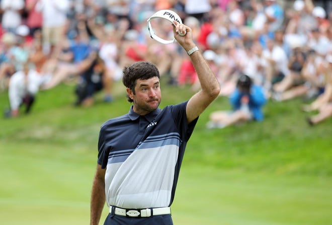 Bubba Watson tips his visor after making a birdie putt on the 18th green to win the Travelers Championship on Sunday in Cromwell, Conn. [Stew Milne/The Associated Press]