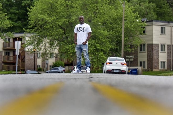 Chris Phillips stands in the spot where Michael Brown was killed in 2014. Residents in the neighborhood where the shooting happened said they feel like they've been left behind while other, more affluent portions of the city have benefited from new development since the riots of 2014. [JAHI CHIKWENDIU/WASHINGTON POST]