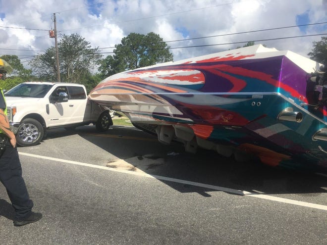 A Panama City woman was seriously injured in a wreck with a boat trailer that sent this speedboat into the roadway. [CONTRIBUTED PHOTO]