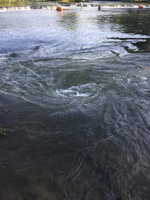 FILE - This Sunday, June 10, 2018 photo provided by provided by the Arkansas Game and Fish Commission shows a whirlpool along the Spring River in northeastern Arkansas. Arkansas has hired a consultant to evaluate a stretch of river where a kayaker was dragged to his death when a rare sinkhole created a whirlpool. Commissioner of State Lands John Thurston says experts will begin evaluating the Spring River on Monday, June 25. The sinkhole area is closed to the public. (AP Photo/Arkansas Game and Fish Commission)
