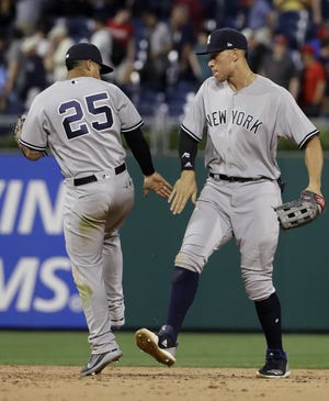 New York Yankees' Gleyber Torres, left, and Aaron Judge celebrate after the Yankees beat the Phillies Monday night at Citizens Bank Park. Judge had two hits, including a home run, and scored two of the Yankees four runs in the game. [MATT SLOCUM / THE ASSOCIATED PRESS]