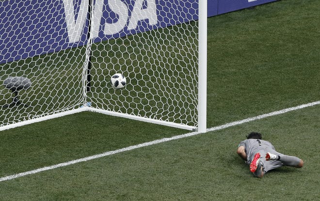 Panama goalkeeper Jaime Penedo lies on the ground after failing to stop a goal from England's Jesse Lingard during the group G match against England at the 2018 World Cup in Nizhny Novgorod, Russia, on Sunday. [AP Photo / Darko Bandic]