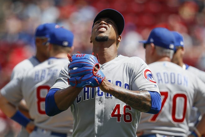 Chicago Cubs relief pitcher Pedro Strop reacts after being relieved in the seventh inning against the Cincinnati Reds on Sunday in Cincinnati. [JOHN MINCHILLO/THE ASSOCIATED PRESS]