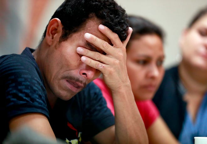 Melvin, foreground, and Iris, both from Honduras, listen as they hear other immigrants tell of their separation from their children at the border during a news conference at the Annunciation House, Monday, June 25, 2018, in El Paso, Texas. 32 parents waiting to be reconciled with their children have been released by Border Patrol the the Annunciation House. (AP Photo/Matt York)