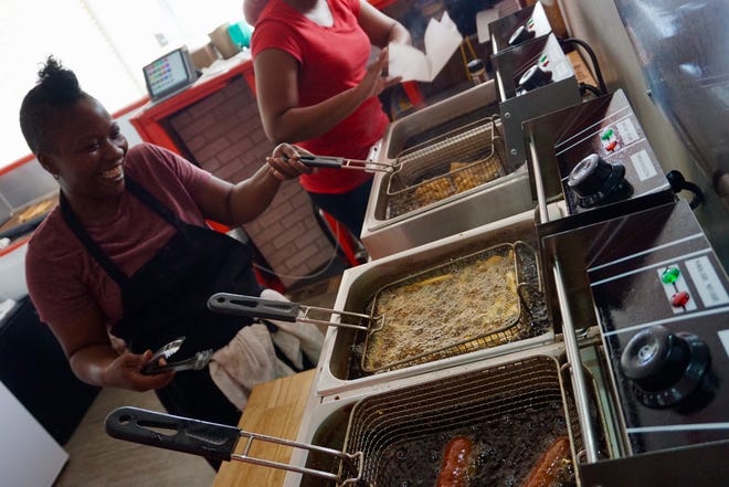 Owner Sherese Johnson works the fryer on Tuesday at the Heart & Soul Cafe, one of Lincoln's newest local businesses. [Photo by The Courier]