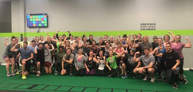 A recent group at Fitness U.S. celebrates completion of a 4-6 week transformation boot camp. [CONTRIBUTED PHOTO]