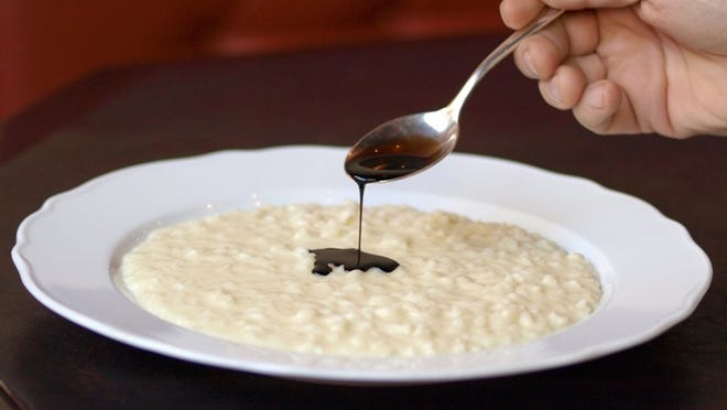 Parmesan risotto with balsamic (which is being poured with a spoon); photo courtesy Sant Ambroeus.