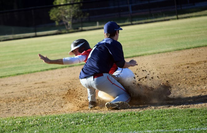 Portsmouth Booma Post 6 baserunner Peyton Goodrich slides safely into third base as Exeter Post 32 third baseman John Hawkins tries to dig up the ball during Tuesday's American Legion baseball game at Phillips Exeter Academy. [Ryan O'Leary/Seacoastonline]