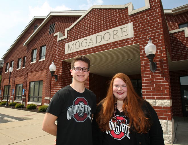 Recent Mogadore High School graduates Joseph Hughes, 18 (left) and Delaney Brake, 17, stand in front of the school Monday, June 18 in Mogadore. Hughes and Brake both received full four-year-scholarships to the Ohio State University beginning this fall.