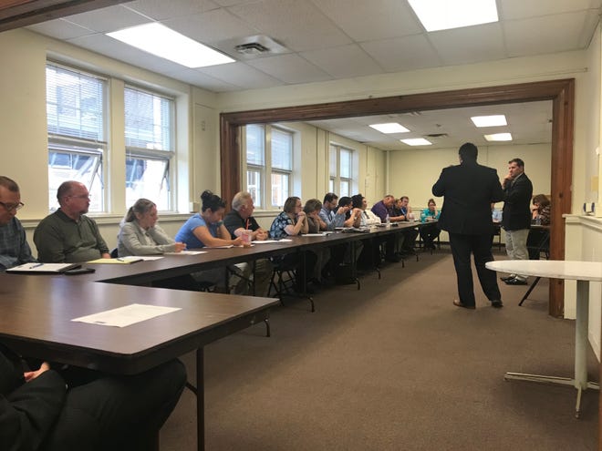 A group of Portage County elected officials and department heads meet with representatives from Clemans-Nelson to discuss a countywide wage study.