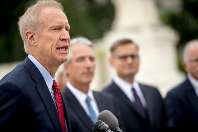 Illinois Gov. Bruce Rauner, left, accompanied by Liberty Justice Center founder and chairman John Tillman, second from left, and Liberty Justice Center's Director of Litigation Jacob Huebert, right, speaks outside the Supreme Court after the court rules in a setback for organized labor that states can't force government workers to pay union fees, in Washington, Wednesday, June 27, 2018. (AP Photo/Andrew Harnik)