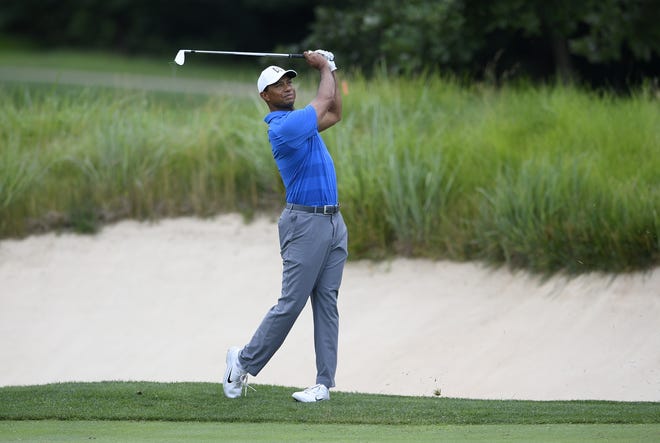 Tiger Woods watches his shot on the first fairway during the Quicken Loans National golf tournament Pro-Am, Wednesday, June 27, 2018, in Potomac, Md. (AP Photo/Nick Wass)