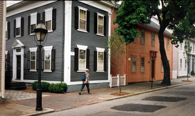 Pedestrian enjoys the atmosphere of preserved homes along Benefit Street, in Providence. [PROVIDENCE JOURNAL FILE]