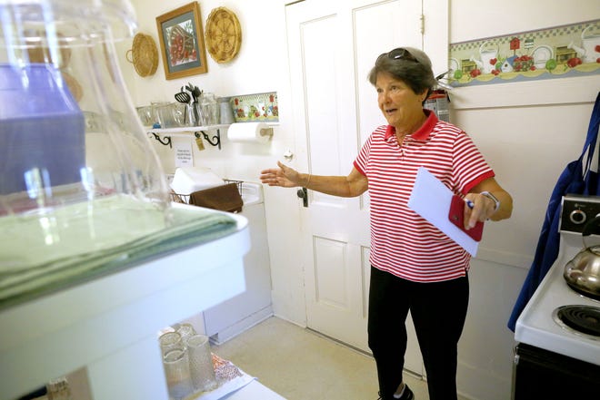Sarah Chesrown, a member of the Melrose Women's Club, shows how much of the kitchen will be lost after a renovation of the restroom at Women's Club, in Melrose Tuesday June 27, 2018. The Melrose Woman´s Club, which is on the National Register of Historic Places, is using grants to refurbish and update the building. [Brad McClenny/The Gainesville Sun]