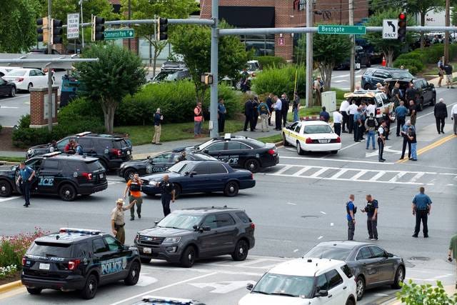 Maryland police officers block the intersection near the building entrance, after multiple people were shot at the Capital Gazette newspaper office in Annapolis, Md., on Thursday. PHOTO BY JOSE LUIS MAGANA/ASSOCIATED PRESS