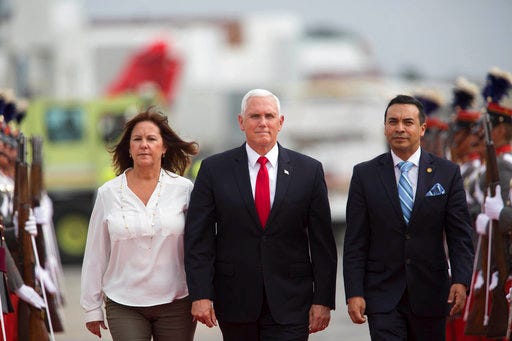 U.S. Vice President Mike Pence, center, walks with his wife Karen as they are escorted by Guatemala's Vice Foreign Minister Pablo Cesar Garcia Saenz, upon arrival to an air force base in Guatemala City, Thursday, June 28, 2018. Pence will meet with leaders from Guatemala, El Salvador and Honduras on immigration issues. (AP Photo/Luis Soto)