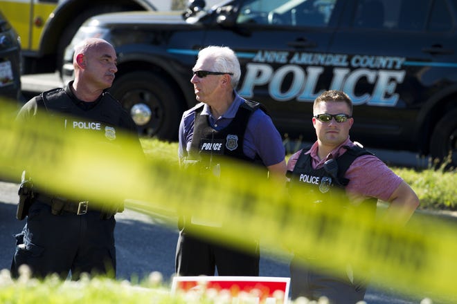 Police officers secure the area after multiple people were shot at an office building housing The Capital Gazette newspaper in Annapolis, Md., Thursday, June 28, 2018. (AP Photo/Jose Luis Magana)