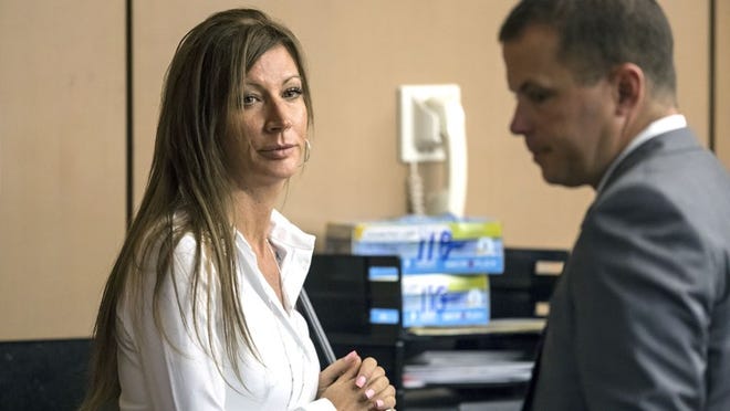 Kristin Cook stands with her attorney after pleading guilty Thursday, June 28, 2018. Cook,  the former office manager of high-end Wellington equestrian shop P.J. Saddles, was accused of embezzling tens of thousands of dollars and fleeing to California.  (Lannis Waters / The Palm Beach Post)