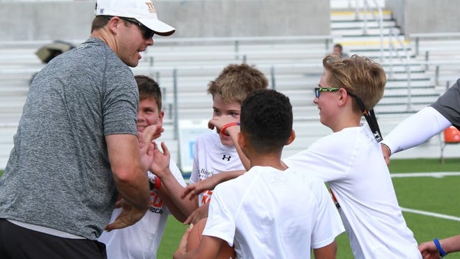 Former University of Texas quarterback Colt McCoy works with area children during his annual Austin football camp Tuesday, June 26, at The Pfield in Pflugerville. PHOTO COURTESY PFLUGERVILLE SCHOOL DISTRICT