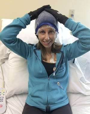Jen Tassi, a runner who successfully used cold-cap therapy to keep her hair during chemo, poses for a photo taken by her husband Pete Tassi on November 14, 2016.