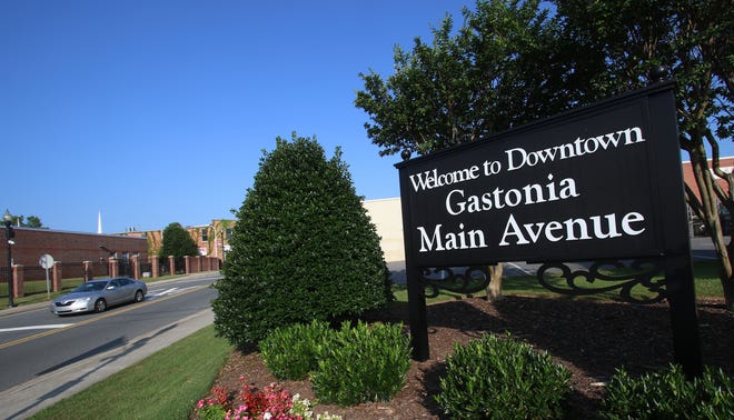 A sign welcoming visitors to downtown Gastonia at the corner of Broad Street and East Main Avenue in Gastonia. The Salvation Army Center of Hope is visible directly across the street. [Mike Hensdill/The Gaston Gazette]