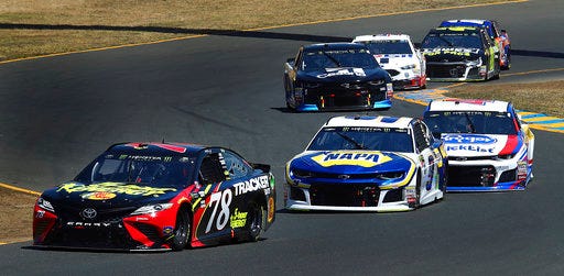 FILE - In this June 24, 2018, file photo, Martin Truex Jr. (78) leads Chase Elliott (9) through a turn during the NASCAR Sprint Cup Series auto race in Sonoma, Calif. Heading to the midpoint of his third season on the NASCAR Cup Series, the 22-year-old Elliott remains in search of his first win. But he is learning more and more about what it takes to compete at the highest level of stock car racing. (AP Photo/Ben Margot, File)