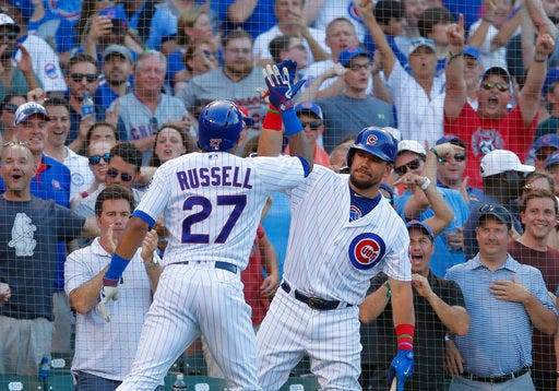 Chicago Cubs' Addison Russell, left, celebrates his grand slam with Kyle Schwarber during the fifth inning of a baseball game against the Minnesota Twins on Friday, June 29, 2018, in Chicago. (AP Photo/Jim Young)